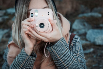woman-hands-holding-a-pink-instax